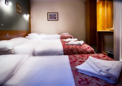 hotel room three beds